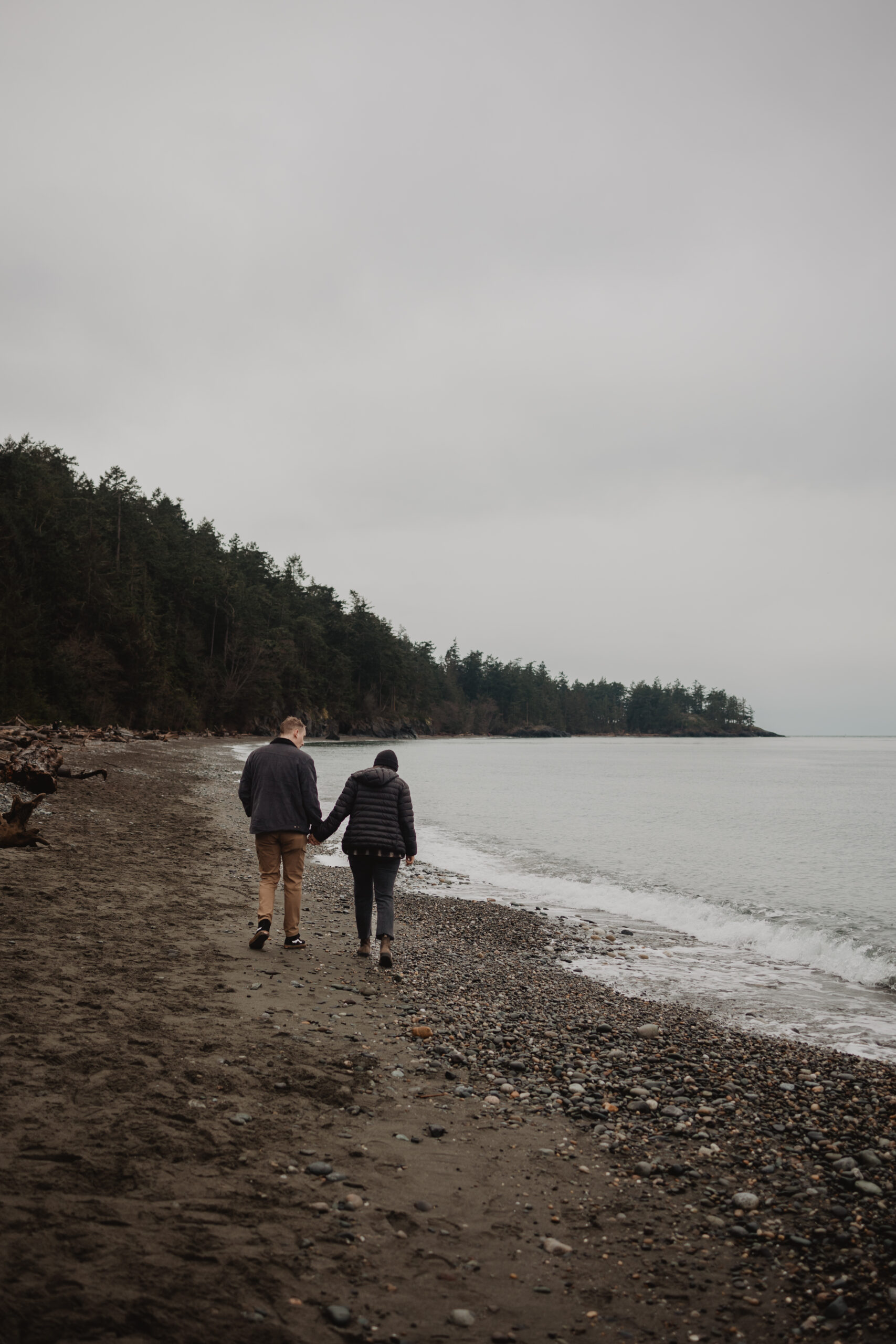 A couple walking along the beach at Deception Pass State Park